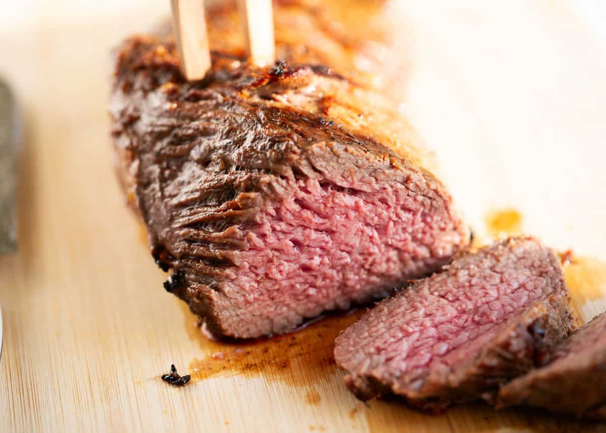 With just a simple marinade, learn how to cook tri tip on the grill or in a smoker for an unforgettable steak dinner that's juicy, tender and beefy! Sliced Tri tip steak.