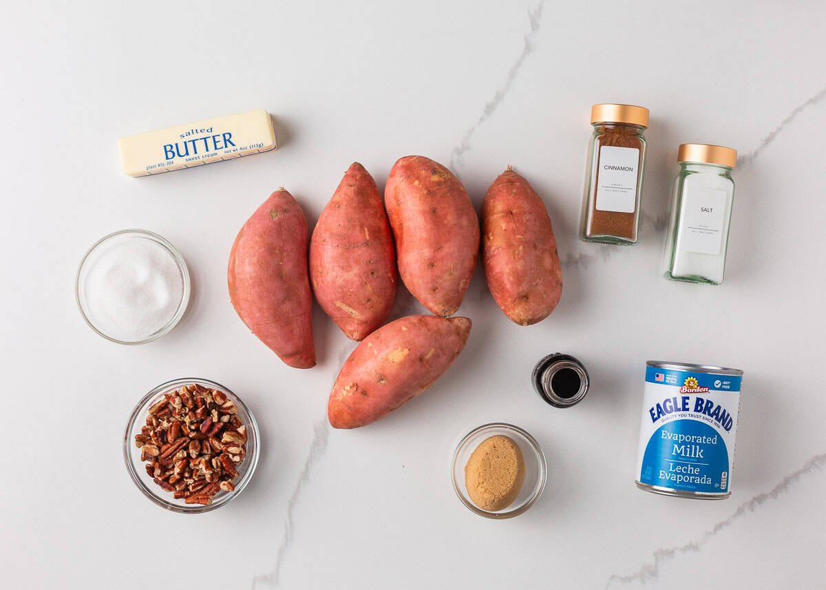 Crockpot sweet potato casserole makes holiday cooking easy. With creamy mashed sweet potatoes and a crunchy pecan topping, it's a holiday side dish not to be missed! Sweet potatoes, butter, sugar, evaporated milk, spices and pecans on the counter for slow cooker sweet potato casserole.