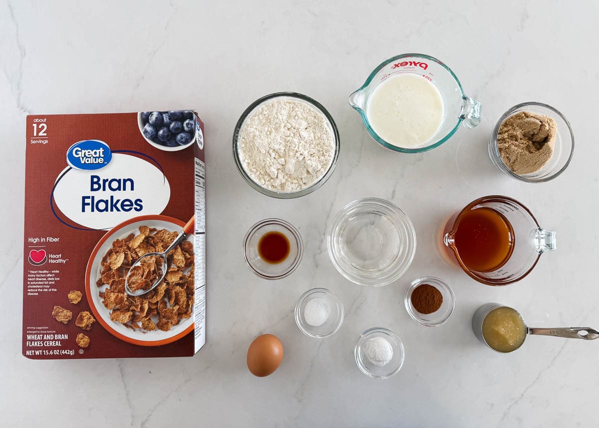 These classic bran muffins bake up soft, hearty, and lightly sweet. They’re a wholesome recipe perfect for a healthy breakfast or snack. Ingredients for homemade bran muffins, including bran flakes cereal, flour, buttermilk, honey, brown sugar, cinnamon, applesauce, coconut oil, and an egg.