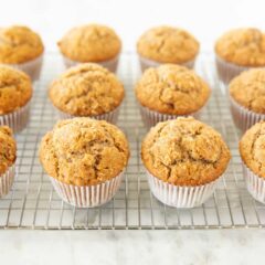 Homemade bran muffins cooling on a wire rack after baking.