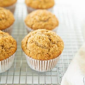 Golden bran muffin cooling on a wire rack after baking.