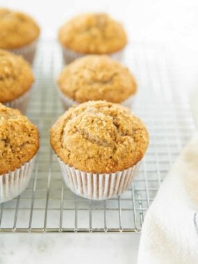 Golden bran muffin cooling on a wire rack after baking.