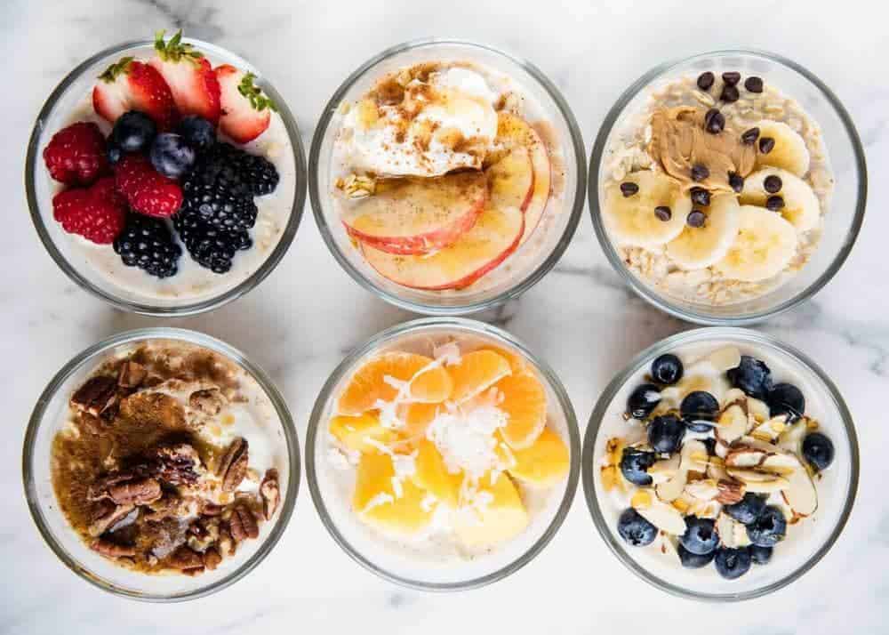 Six jars of assorted overnight oats with customized toppings for an easy breakfast hack.
