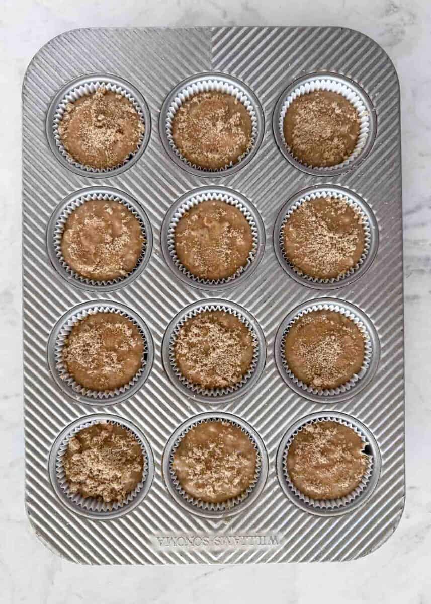 These classic bran muffins bake up soft, hearty, and lightly sweet. They’re a wholesome recipe perfect for a healthy breakfast or snack. Unbaked bran muffin batter divided into a muffin pan and sprinkled with brown sugar.