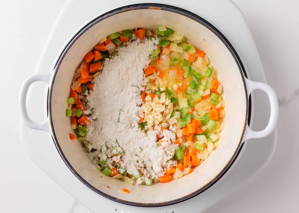 This creamy sausage potato soup is made in one pot with Italian sausage, tender potatoes, and a cheesy broth, it's a cozy way to satisfy the whole family! Sauteing mirepoix garlic and flour.