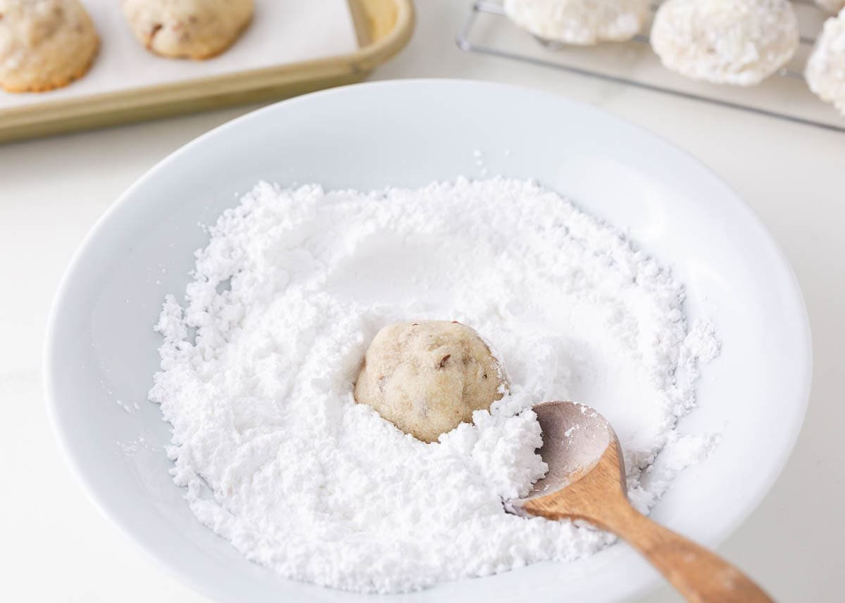 Snowball cookies are a holiday classic made with buttery shortbread studded with crunchy pecans and coated in powdered sugar. Perfect for Christmas cookie trays!