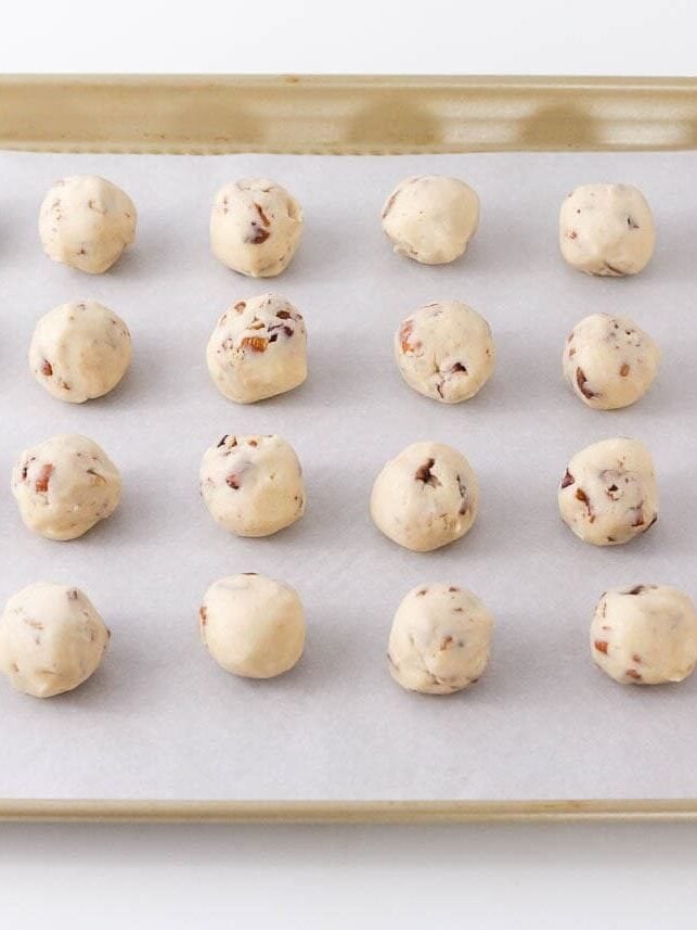 Snowball cookies are a holiday classic made with buttery shortbread studded with crunchy pecans and coated in powdered sugar. Perfect for Christmas cookie trays!