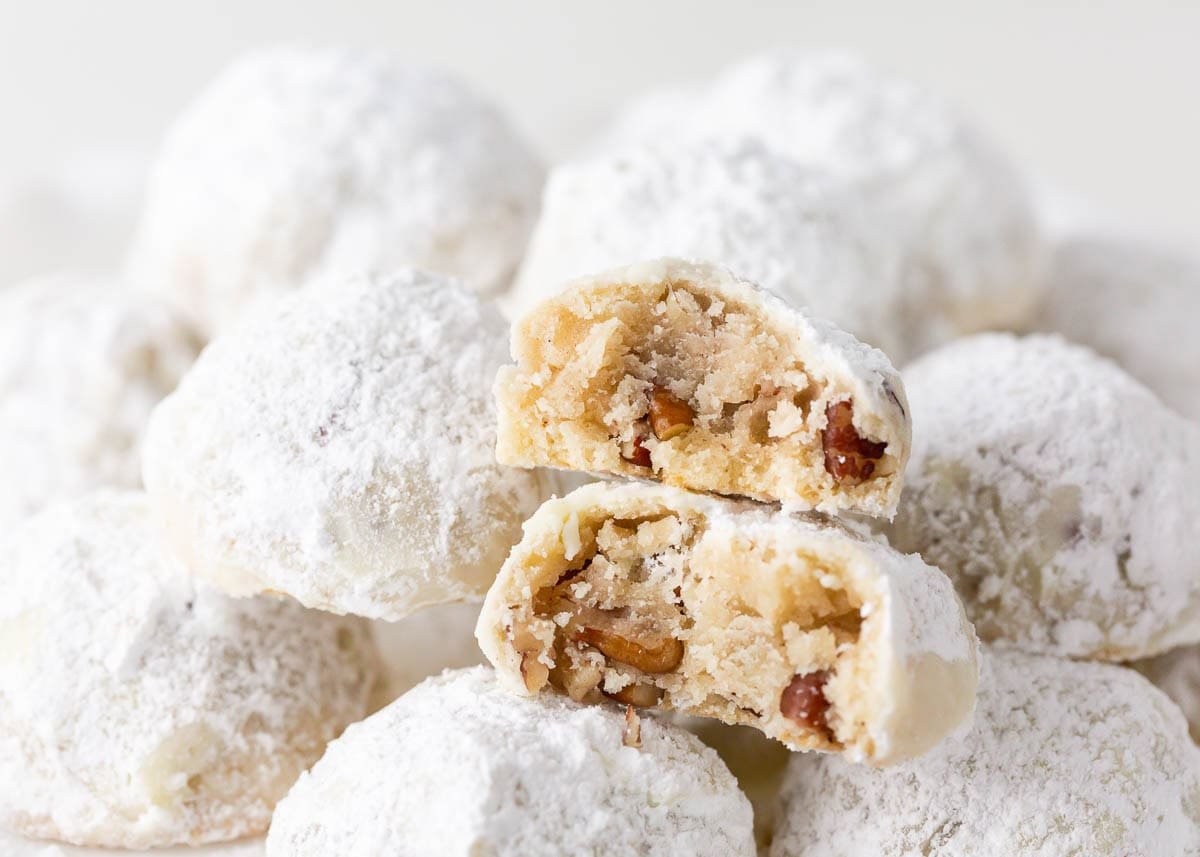 Snowball cookies are a holiday classic made with buttery shortbread studded with crunchy pecans and coated in powdered sugar. Perfect for Christmas cookie trays! Snowball cookies.