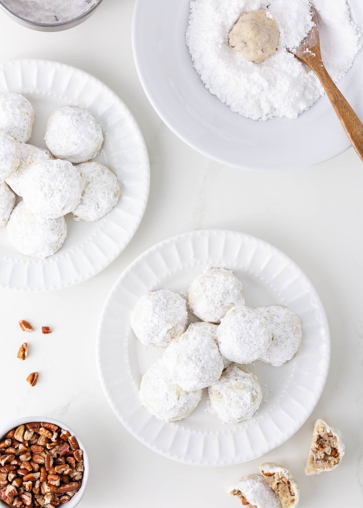 Snowball cookies are a holiday classic made with buttery shortbread studded with crunchy pecans and coated in powdered sugar. Perfect for Christmas cookie trays!