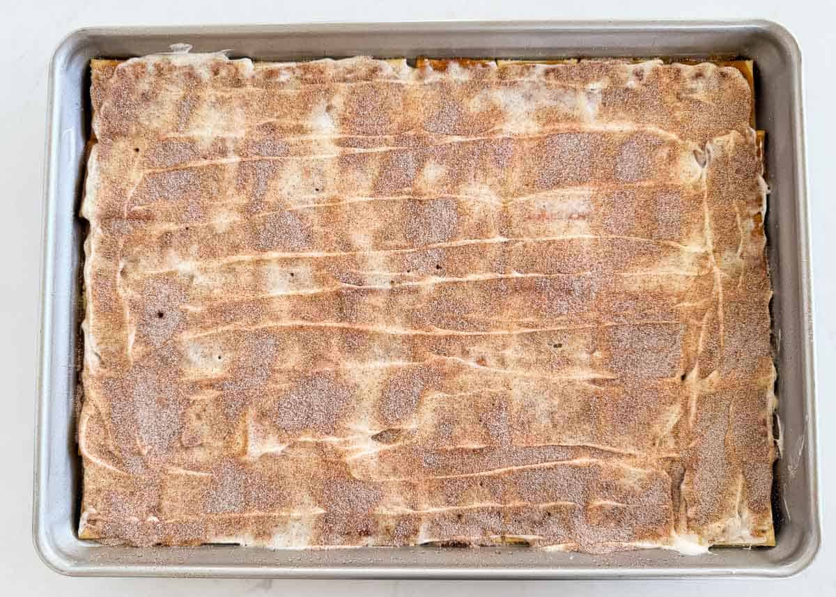 Churro saltine toffee coated in white chocolate, sprinkled with cinnamon sugar.