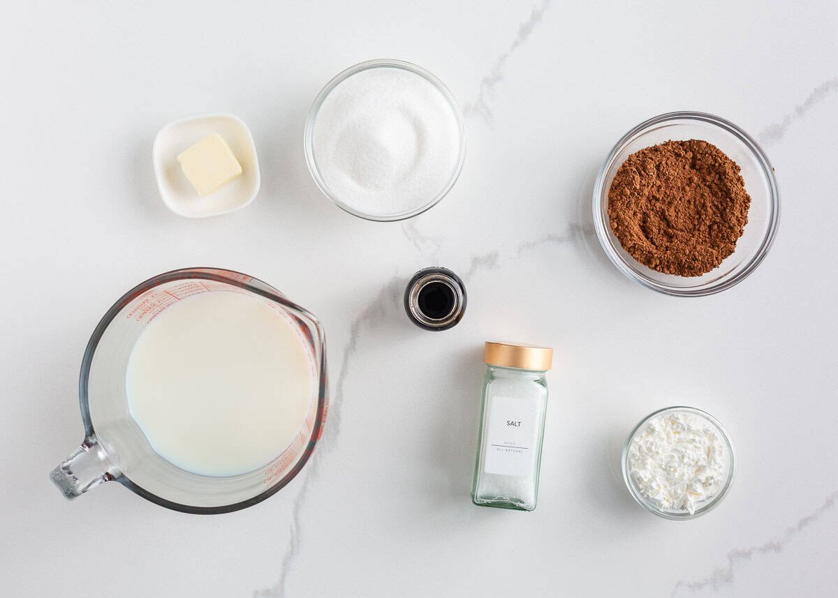 This homemade chocolate pudding is rich, creamy, and easy to make from scratch with just a few simple ingredients. It's just the treat when a chocolate craving hits! Homemade chocolate pudding ingredients measured out on a counter, including milk, sugar, cocoa powder, cornstarch, vanilla, butter, and salt.