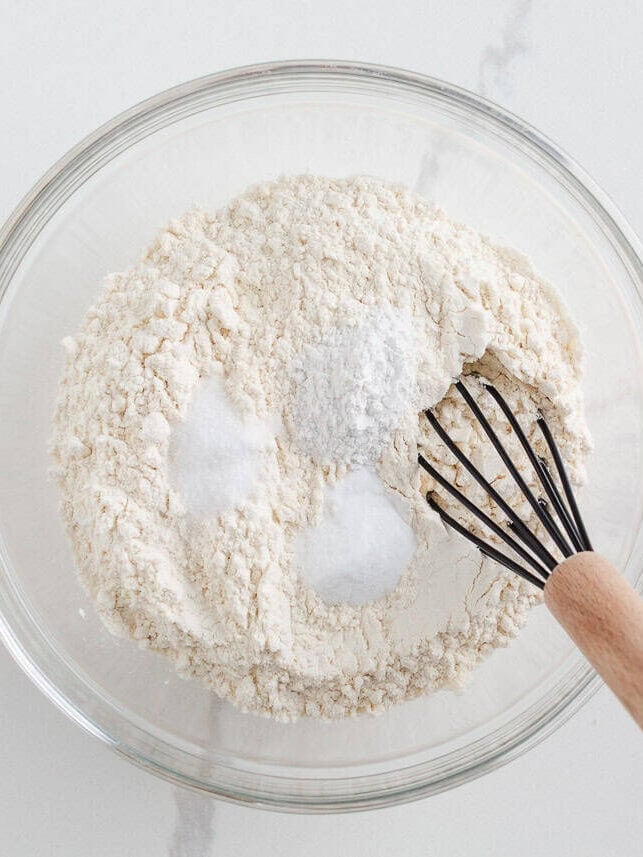Whisk combining flour, baking powder, baking soda, and salt in a bowl.