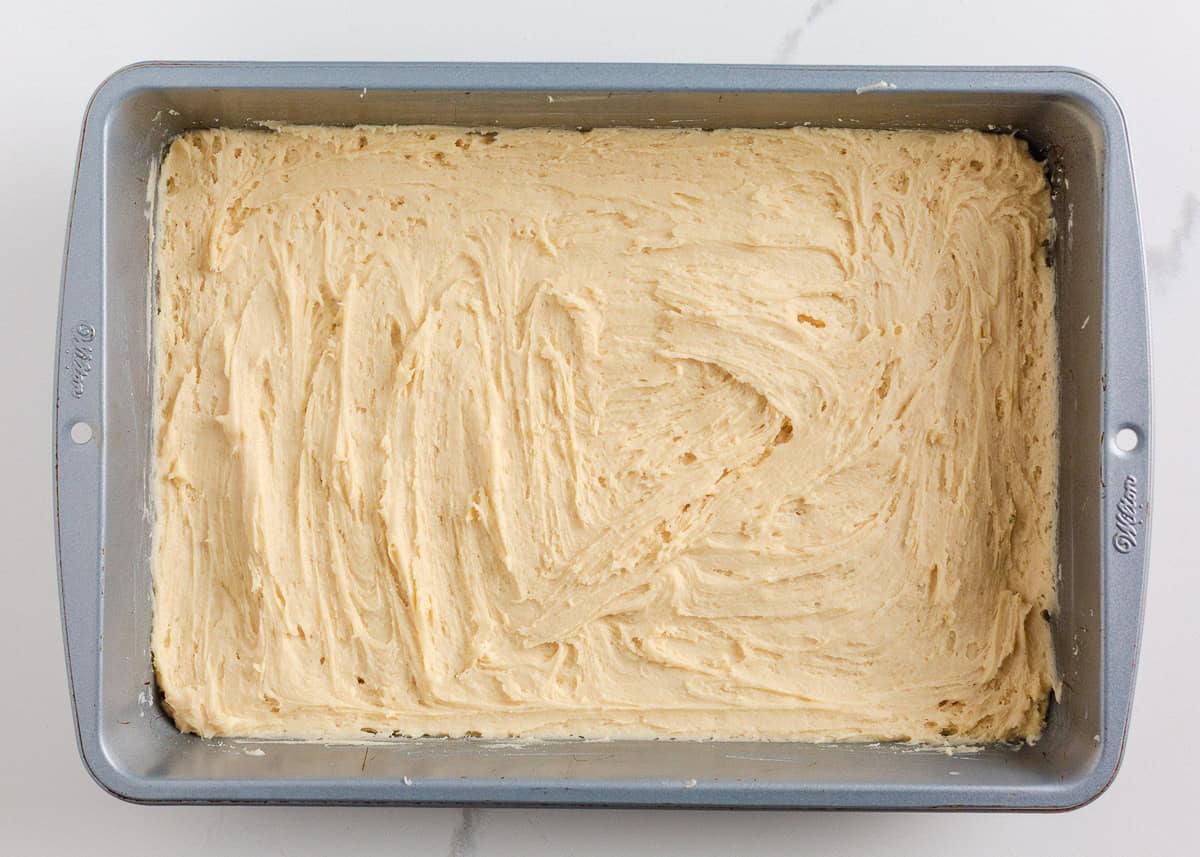 Sugar cookie dough pressed into a 9x13 baking pan before baking.