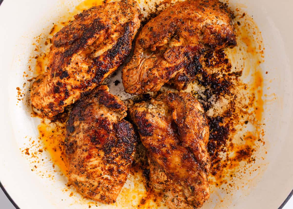 Make perfectly seasoned blackened chicken with a smoky crust and tender, juicy middle. Serve it over creamy Alfredo, rice, or salad for an easy way to add big flavor to any dinner. Blackened chicken breasts cooking in a hot skillet with a golden, spice-rubbed crust.