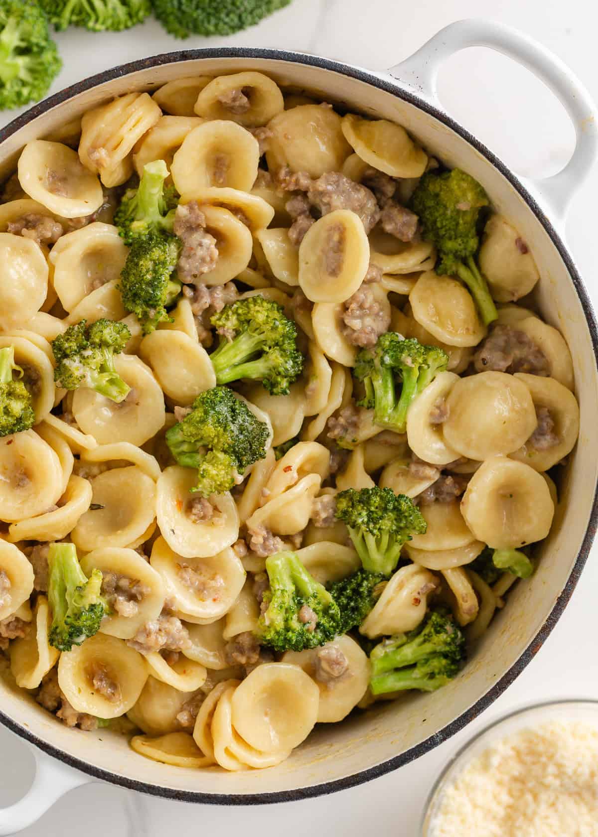 This orecchiette pasta with sausage and broccoli is simmered in a light, creamy sauce until the pasta is tender and the broccoli is bright. It’s a comforting one-pan meal ready in 30 minutes! A large pot filled with orecchiette pasta mixed with browned sausage and bright green broccoli florets in a creamy sauce.