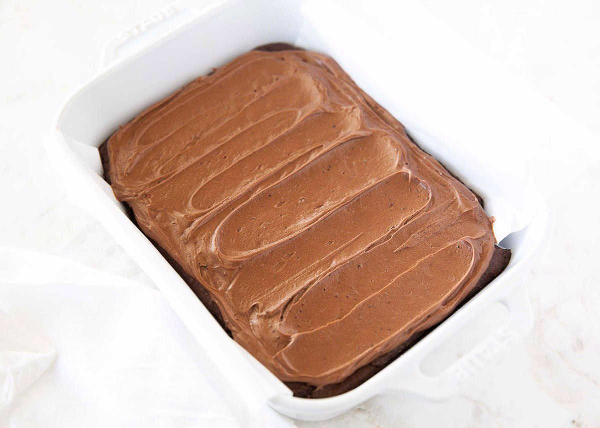 Pan of brownies swirled with brownie frosting across the top.