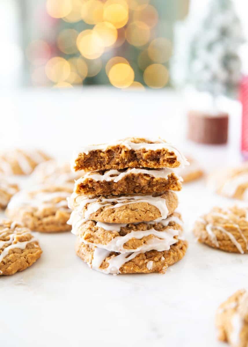 Stack of gingerbread oatmeal cookies with a bite taken out of the top cookie to show the soft center.