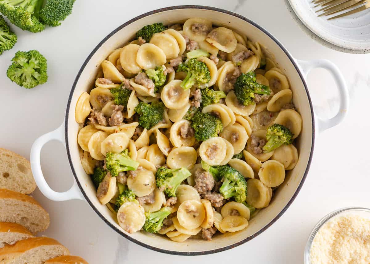 This orecchiette pasta with sausage and broccoli is simmered in a light, creamy sauce until the pasta is tender and the broccoli is bright. It’s a comforting one-pan meal ready in 30 minutes! A pot of creamy orecchiette pasta mixed with sausage and tender broccoli, ready to serve.