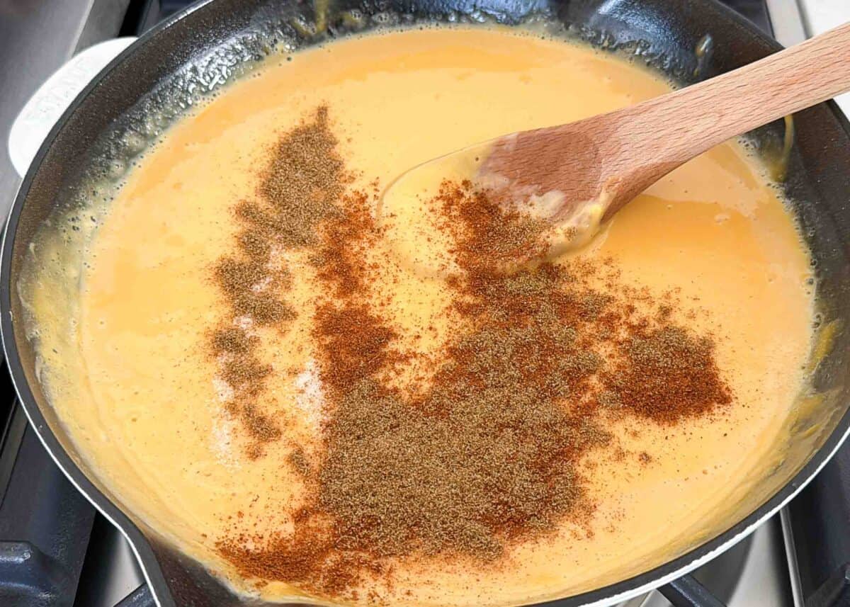 Skip the restaurant run. This Chili’s skillet queso copycat is made in under 10 minutes with Velveeta, chili, milk, and a simple blend of spices for a creamy, crowd-pleasing dip. Chili's skillet queso ingredients stirred together in a skillet.