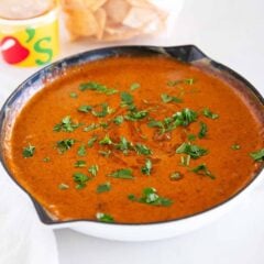 Warm skillet of Chili’s queso topped with fresh cilantro, ready to serve as a copycat Chili’s skillet queso recipe.