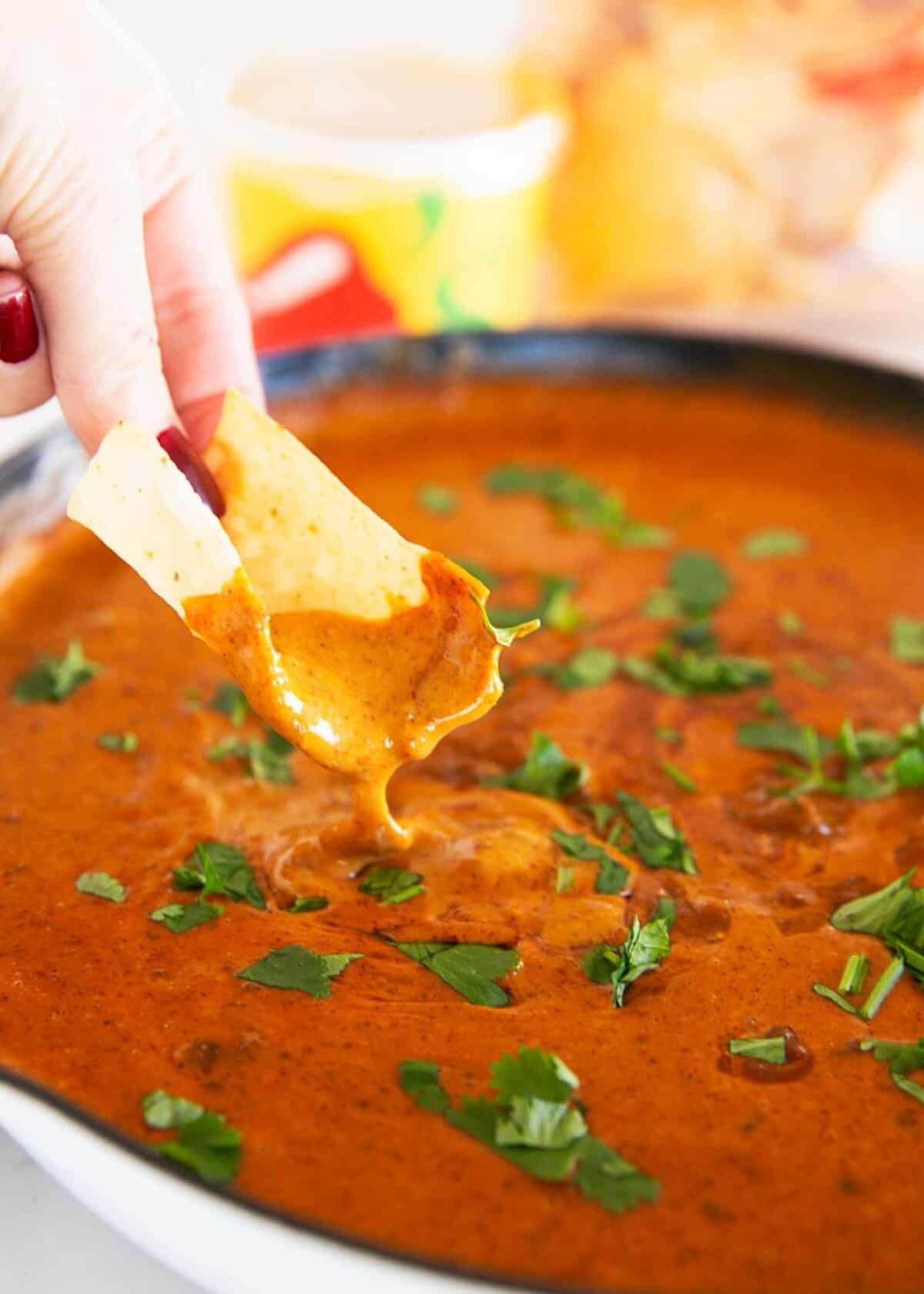 Skip the restaurant run. This Chili’s skillet queso copycat is made in under 10 minutes with Velveeta, chili, milk, and a simple blend of spices for a creamy, crowd-pleasing dip. Tortilla chip dipped into smooth and creamy Chili’s skillet queso in a skillet for a homemade copycat version.