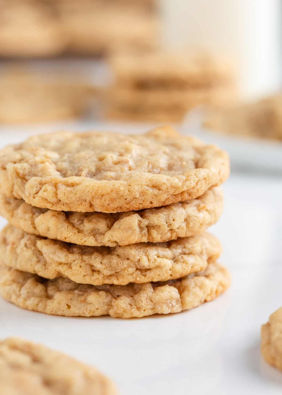 These easy oatmeal cookies are a quick treat made in only one bowl. They turn perfectly every time with a buttery brown sugar taste, crisp edges and a soft, chewy center! Stack of soft and chewy easy oatmeal cookies with crisp, golden edges on a white surface.