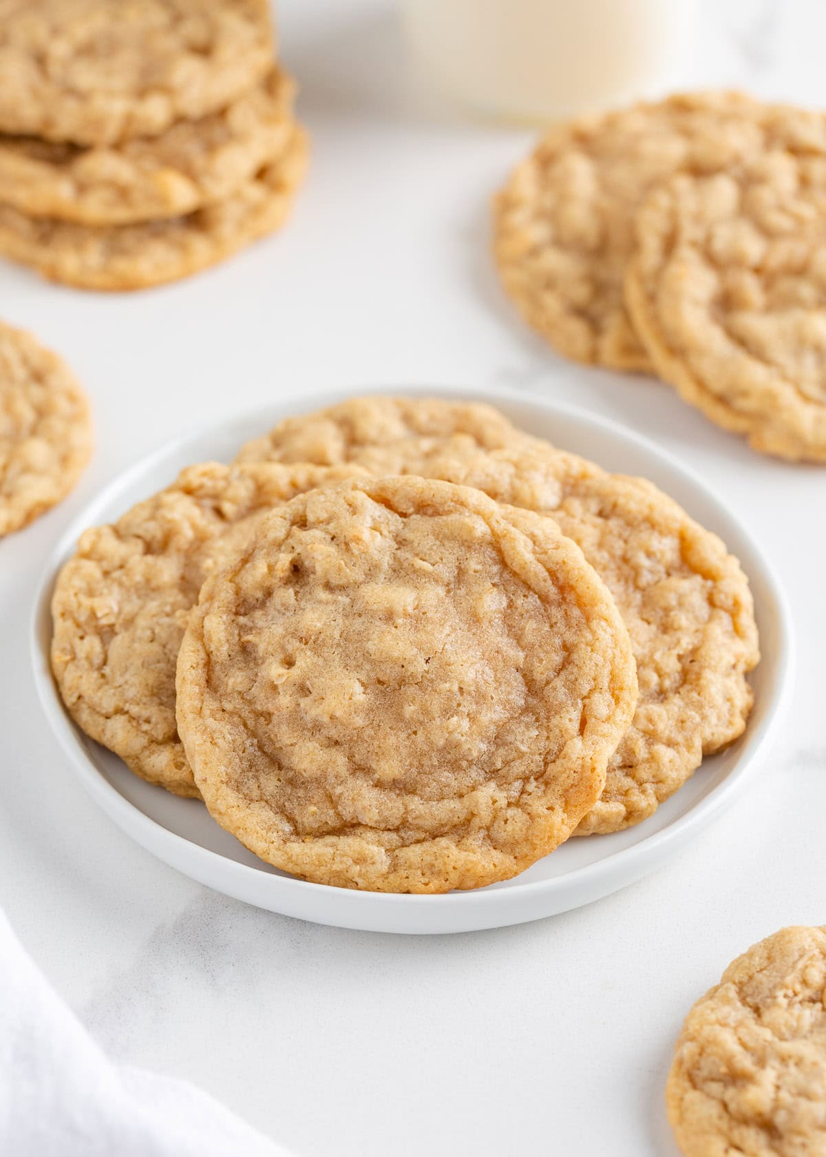 Soft homemade oatmeal cookies on a white plate.