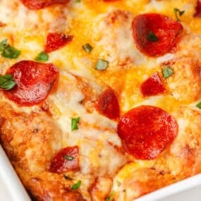 Close-up of pepperoni bubble pizza showing melted cheese and browned biscuit dough.