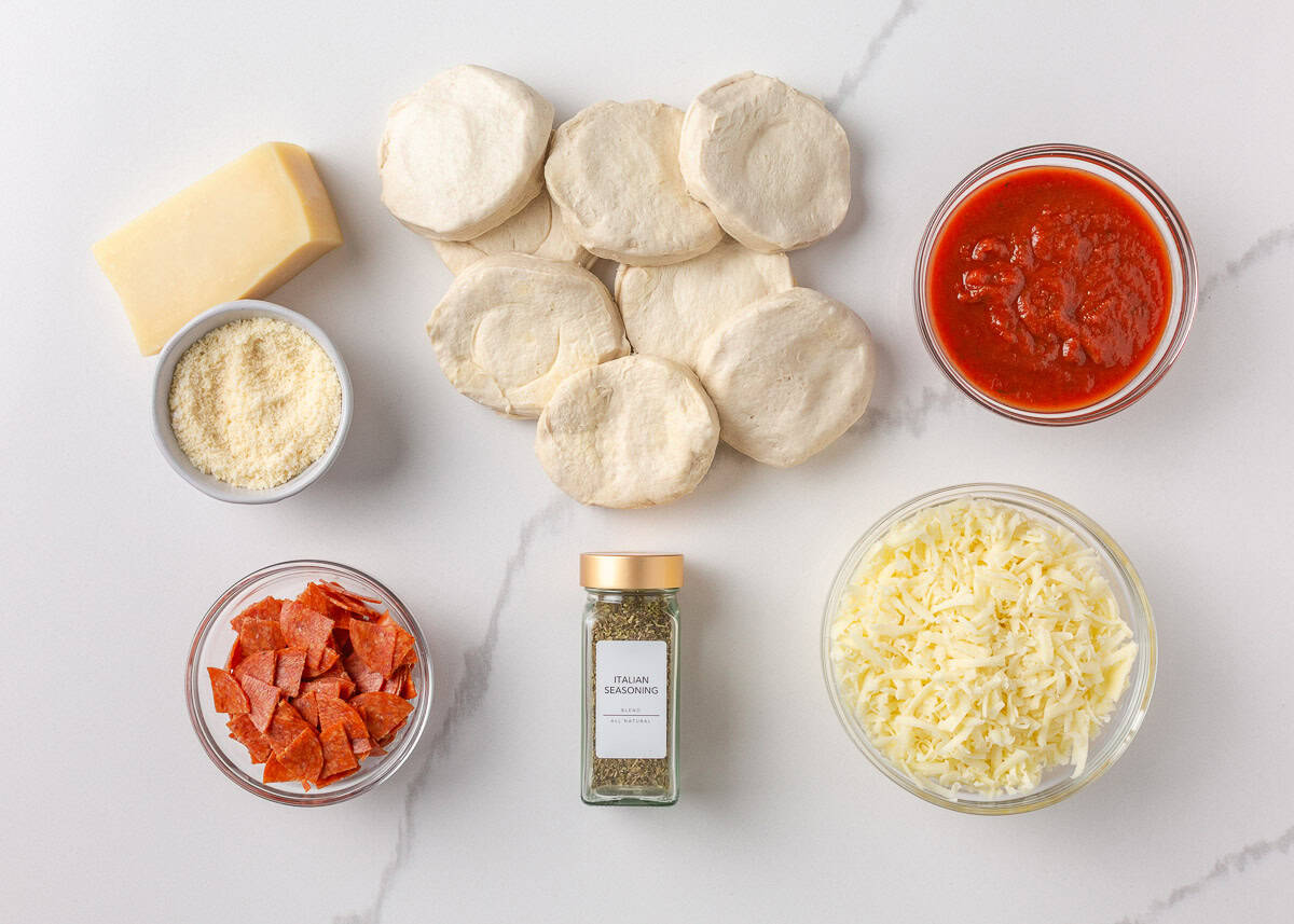 This bubble pizza is an easy way to make pizza at home without the hassle of rolling out dough. Baked into a fun pull-apart style, it’s packed with crowd-pleasing pizza flavor! Ingredients for bubble pizza including biscuit dough, pizza sauce, mozzarella, pepperoni, and Italian seasoning.