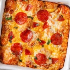 Baked pepperoni bubble pizza with bubbly cheese and crispy pepperoni in a square baking dish.
