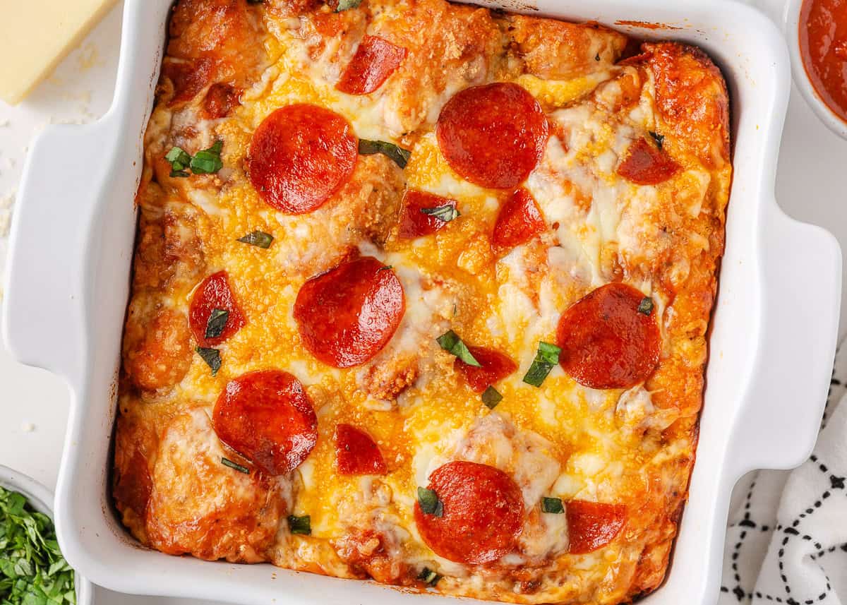 This bubble pizza is an easy way to make pizza at home without the hassle of rolling out dough. Baked into a fun pull-apart style, it’s packed with crowd-pleasing pizza flavor! Baked pepperoni bubble pizza with bubbly cheese and crispy pepperoni in a square baking dish.