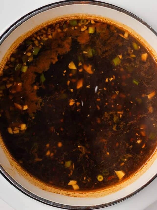 Make this quick and easy homemade chicken ramen with a rich savory broth, tender chicken, noodles, and plenty of your favorite toppings. Seasoned chicken ramen broth after simmering with soy sauce, chili garlic sauce, and aromatics.