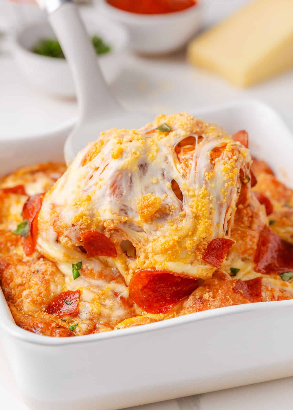 This bubble pizza is an easy way to make pizza at home without the hassle of rolling out dough. Baked into a fun pull-apart style, it’s packed with crowd-pleasing pizza flavor! Pull-apart pepperoni bubble pizza with melted mozzarella and biscuit dough baked in a casserole dish.