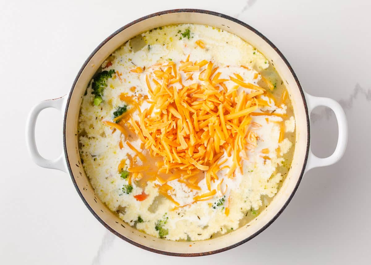 Comforting, easy to make, and packed with flavor, a bowl of this broccoli cheese and potato soup is perfect for cozy dinners! Shredded cheddar cheese melting into the creamy broccoli and potato soup.