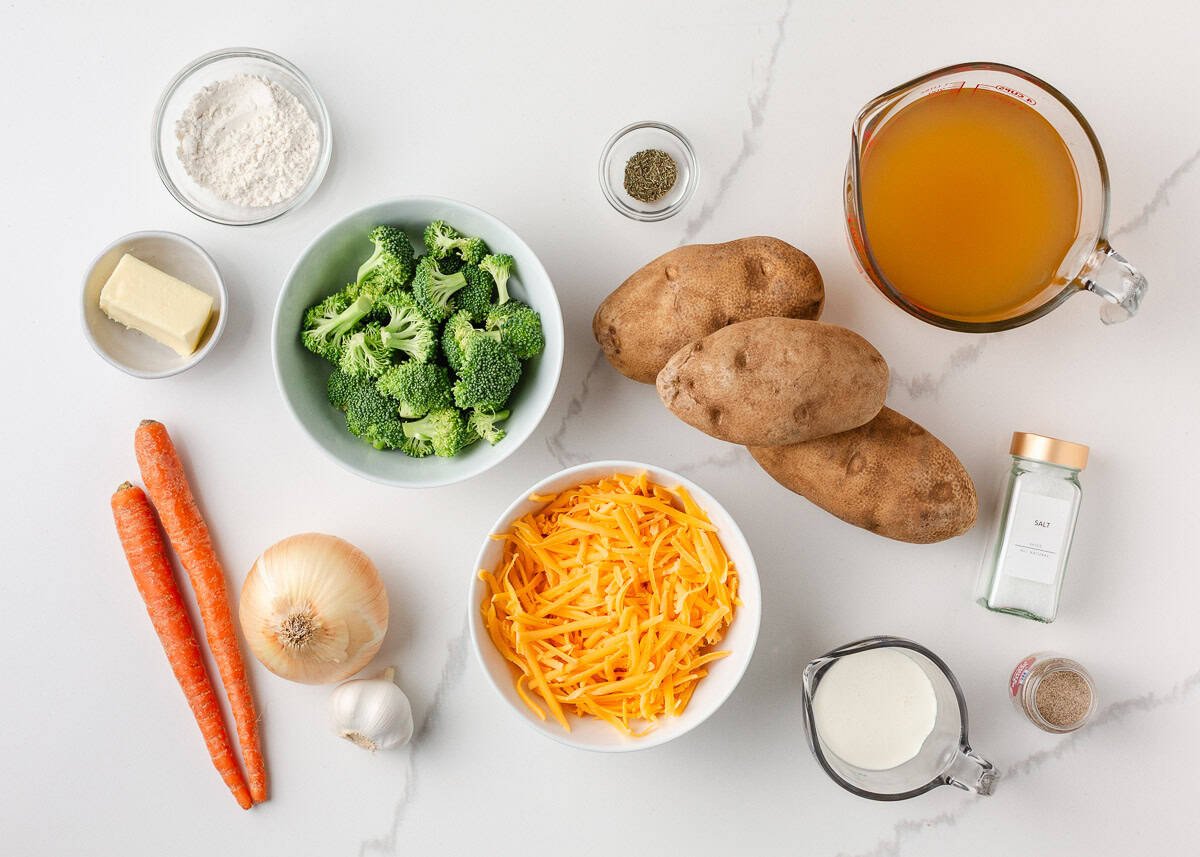Comforting, easy to make, and packed with flavor, a bowl of this broccoli cheese and potato soup is perfect for cozy dinners! Ingredients for broccoli cheese and potato soup including potatoes, broccoli, carrots, onion, cheddar cheese, milk, butter, and broth.