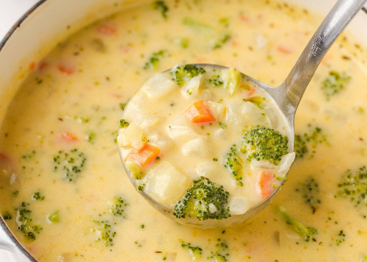 Comforting, easy to make, and packed with flavor, a bowl of this broccoli cheese and potato soup is perfect for cozy dinners! Creamy broccoli cheese and potato soup simmering in a pot with vegetables throughout.