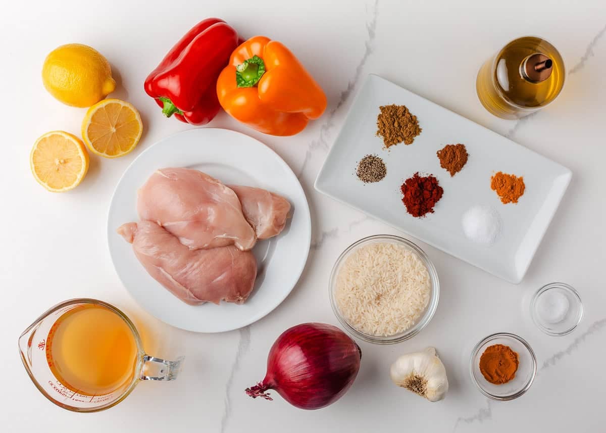 Colorful, fresh, and customizable, these chicken shawarma bowls are packed with bold spices, tender chicken, and all your favorite toppings. Ingredients for chicken shawarma bowls including chicken, spices, rice, lemon, garlic, and vegetables.