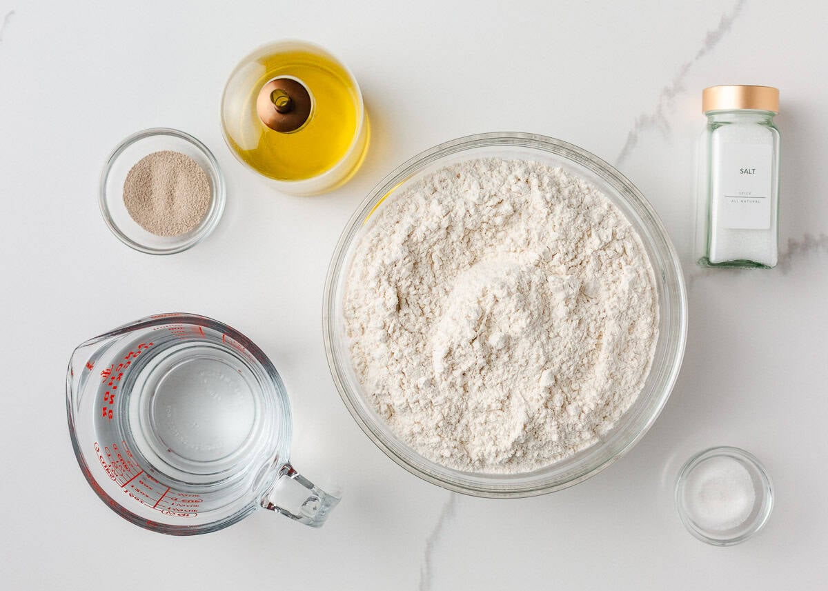 Soft on the inside with a golden, chewy crust, these homemade hoagie rolls are easy to make and instantly upgrade your favorite subs and sandwiches. Ingredients for homemade hoagie rolls including flour, water, olive oil, yeast, salt, and sugar.