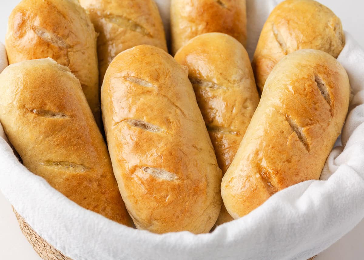 Soft on the inside with a golden, chewy crust, these homemade hoagie rolls are easy to make and instantly upgrade your favorite subs and sandwiches. Freshly baked homemade hoagie rolls in a lined basket.