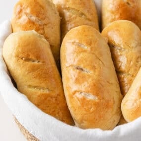 Golden brown homemade hoagie rolls with a soft interior and lightly crisp crust.