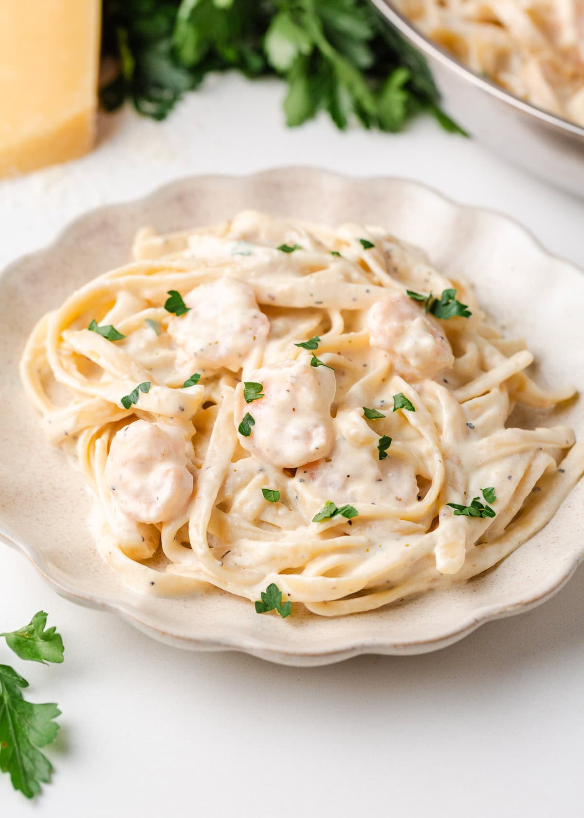 Just a few simple ingredients come together to create this rich and creamy shrimp fettuccine alfredo, ready in 25 minutes! Plate of shrimp alfredo with fettuccine noodles coated in a rich, creamy sauce.