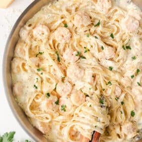 Shrimp fettuccine alfredo tossed in a creamy Parmesan sauce and garnished with parsley.