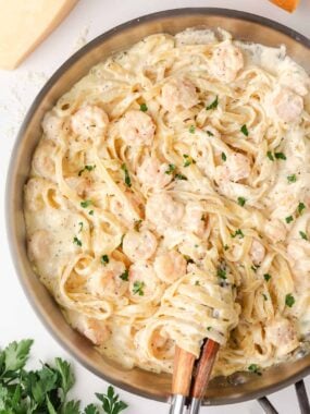 Shrimp fettuccine alfredo tossed in a creamy Parmesan sauce and garnished with parsley.