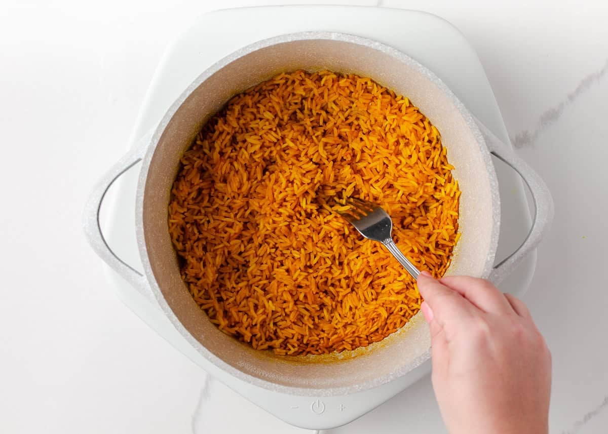 Colorful, fresh, and customizable, these chicken shawarma bowls are packed with bold spices, tender chicken, and all your favorite toppings. Fluffy yellow rice finished cooking for chicken shawarma bowls.