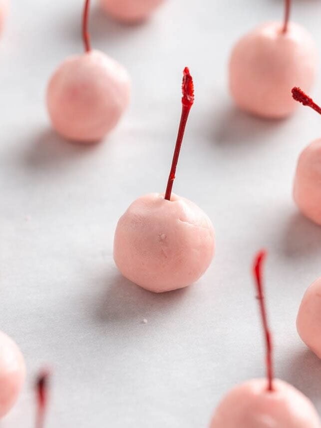 Prepared chocolate covered cherries with the sugar coating set and ready for dipping in chocolate.