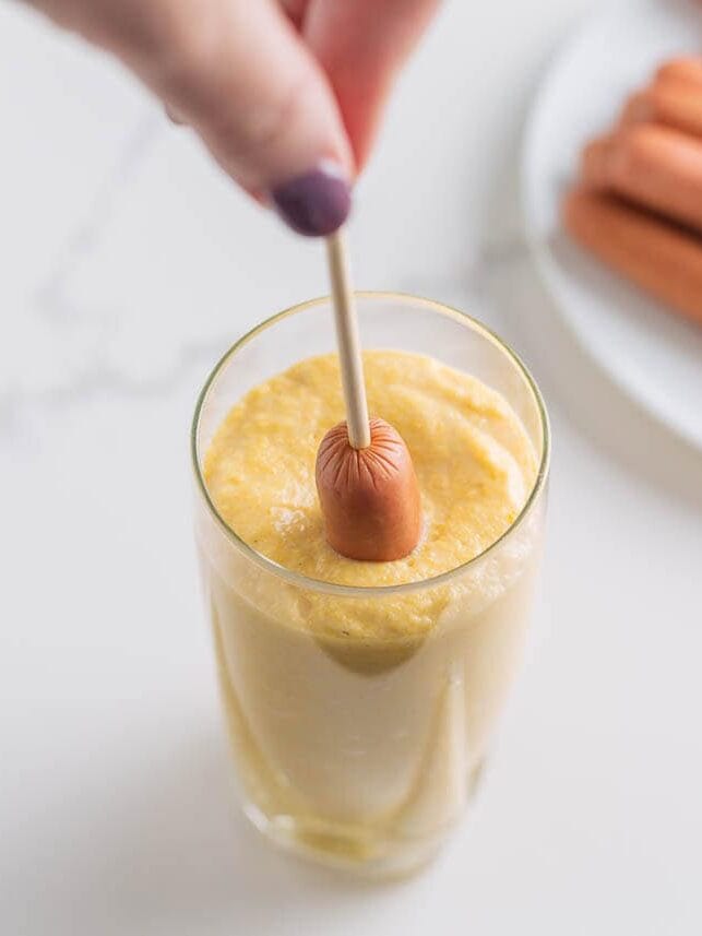 Hot dog on a stick dipped into homemade corn dog batter.