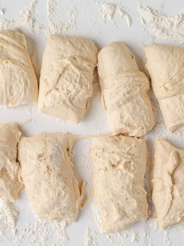 Soft on the inside with a golden, chewy crust, these homemade hoagie rolls are easy to make and instantly upgrade your favorite subs and sandwiches. Dough divided into equal portions for shaping homemade hoagie rolls.