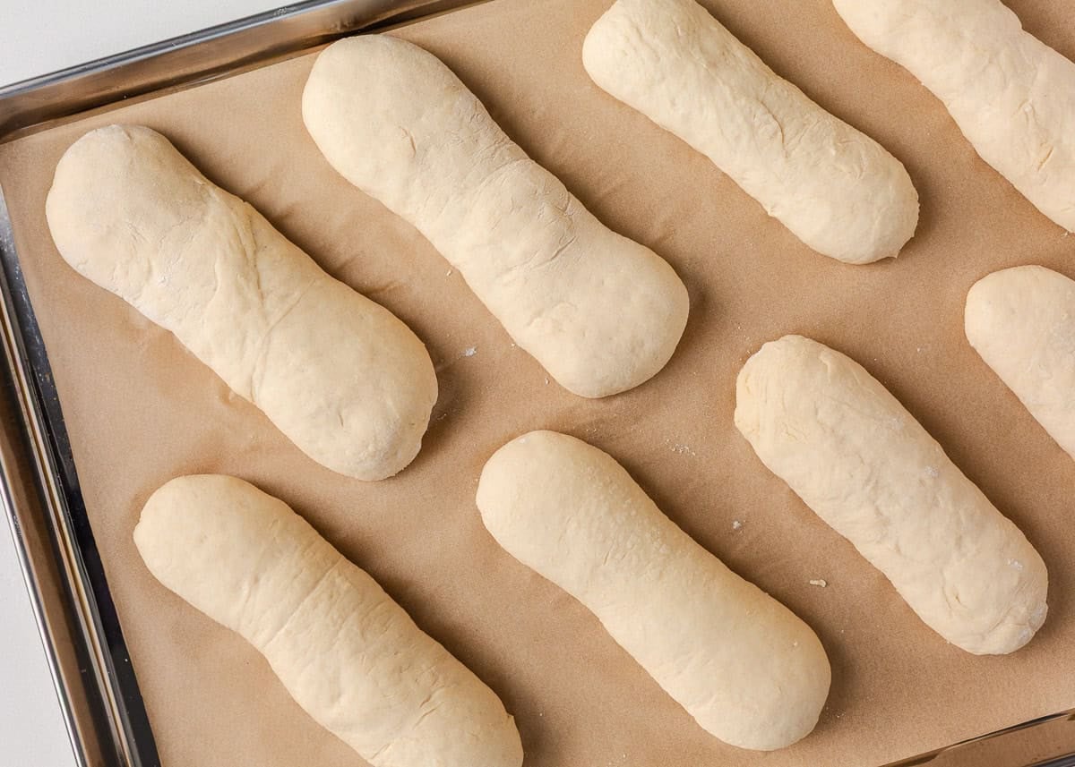 Soft on the inside with a golden, chewy crust, these homemade hoagie rolls are easy to make and instantly upgrade your favorite subs and sandwiches. Shaped hoagie roll dough placed on a parchment-lined baking sheet before the second rise.