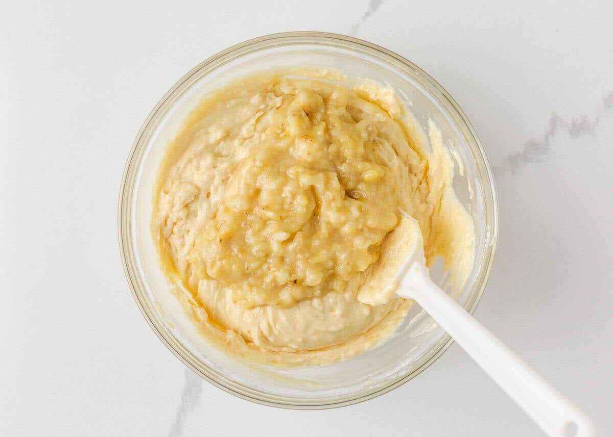 This sour cream banana bread is extra soft, moist, and full of flavor thanks to one simple ingredient. It’s an easy recipe and the perfect way to use up overripe bananas. Sour cream banana bread batter mixed in a glass bowl.
