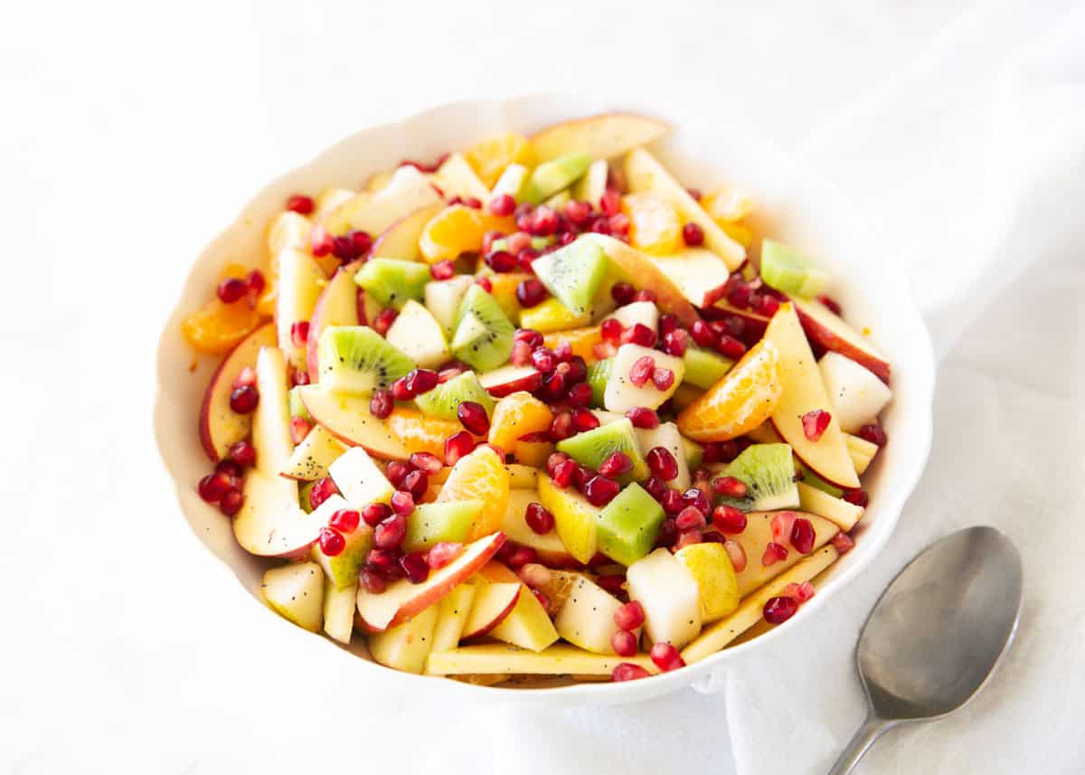 This winter fruit salad is made with apples, pears, kiwi, clementines, and pomegranate arils, then tossed in a light citrus honey dressing. An easy, fresh side dish ready in minutes! Winter fruit salad made with apples, pears, kiwi, clementines, and pomegranate arils tossed in a citrus honey dressing.